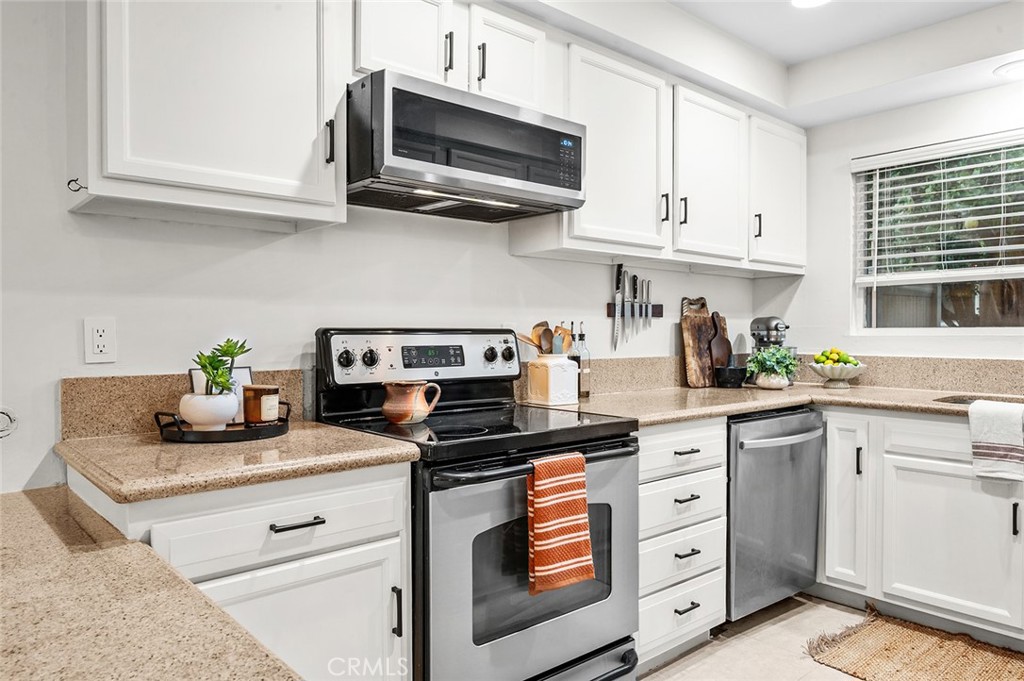 Kitchen with abundant natural light - 1881 Mitchell Avenue 135, Tustin CA 92780 - photo 9