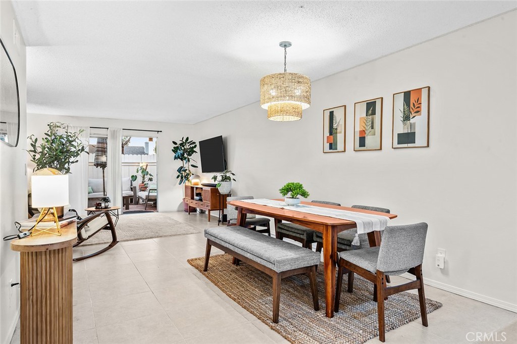 Dining area with adjacent kitchen and breakfast bar. - 1881 Mitchell Avenue 135, Tustin CA 92780 - photo 12