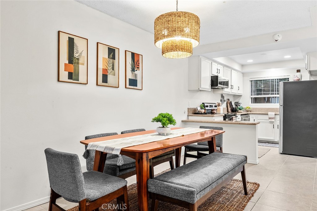 Dining area with open view into the​​‌​​​​‌​​‌‌​​‌‌​​‌‌​​‌​​​‌‌​‌​​​​‌‌​‌​​ kitchen. - 1881 Mitchell Avenue 135, Tustin CA 92780 - photo 13