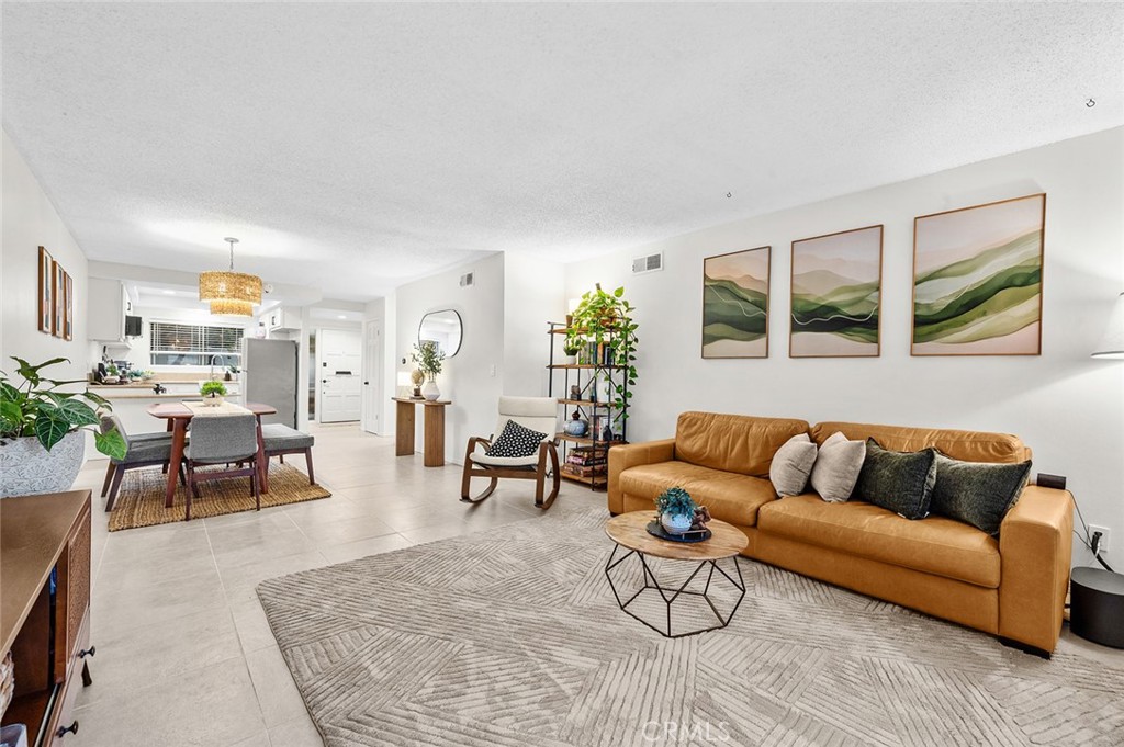 Spacious living and dining areas with an open layout. - 1881 Mitchell Avenue 135, Tustin CA 92780 - photo 17