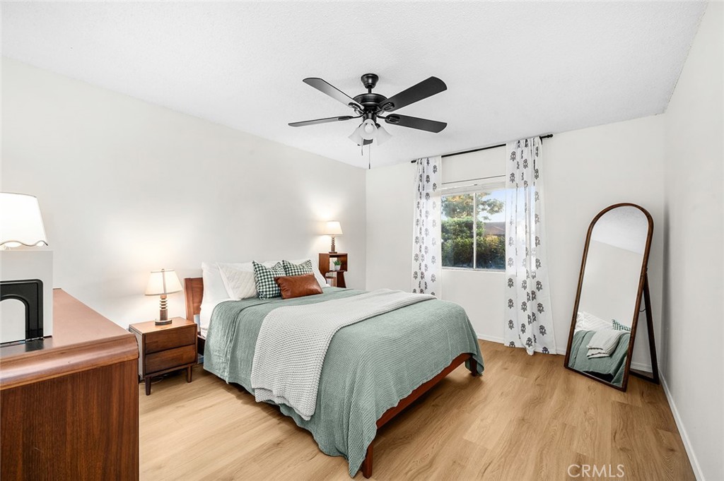 Spacious primary bedroom with new flooring and plenty of natural light - 1881 Mitchell Avenue 135, Tustin CA 92780 - photo 21