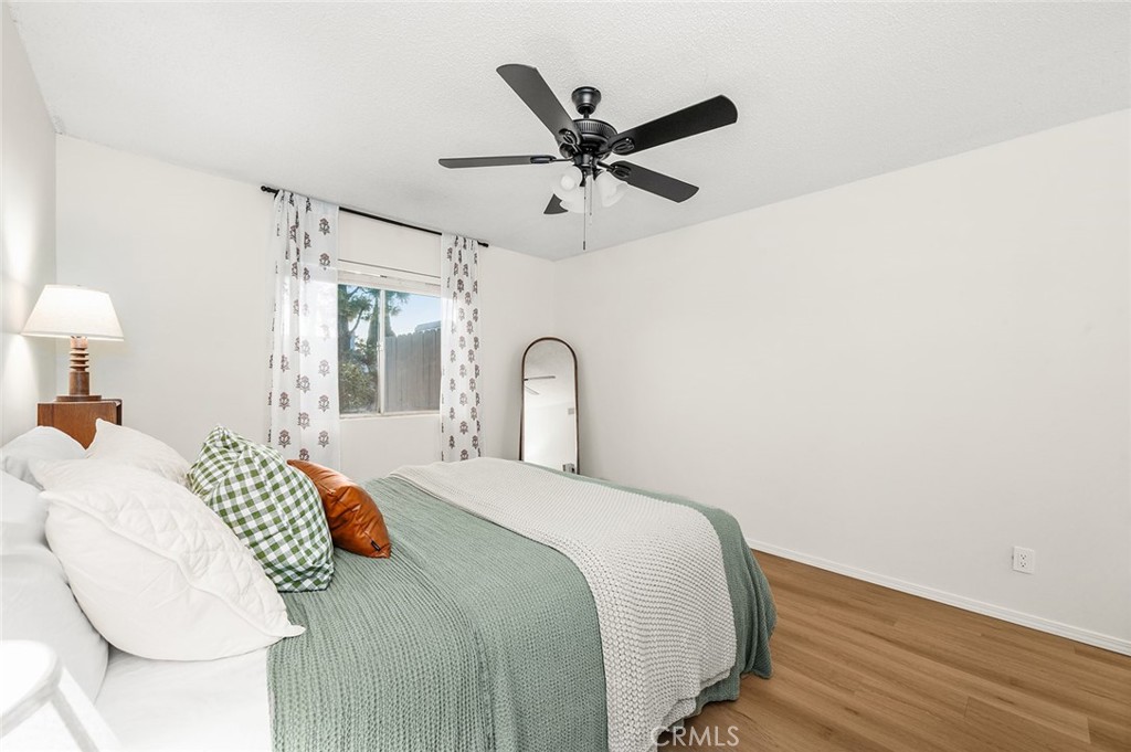 Spacious primary bedroom with new flooring and plenty of natural light - 1881 Mitchell Avenue 135, Tustin CA 92780 - photo 22