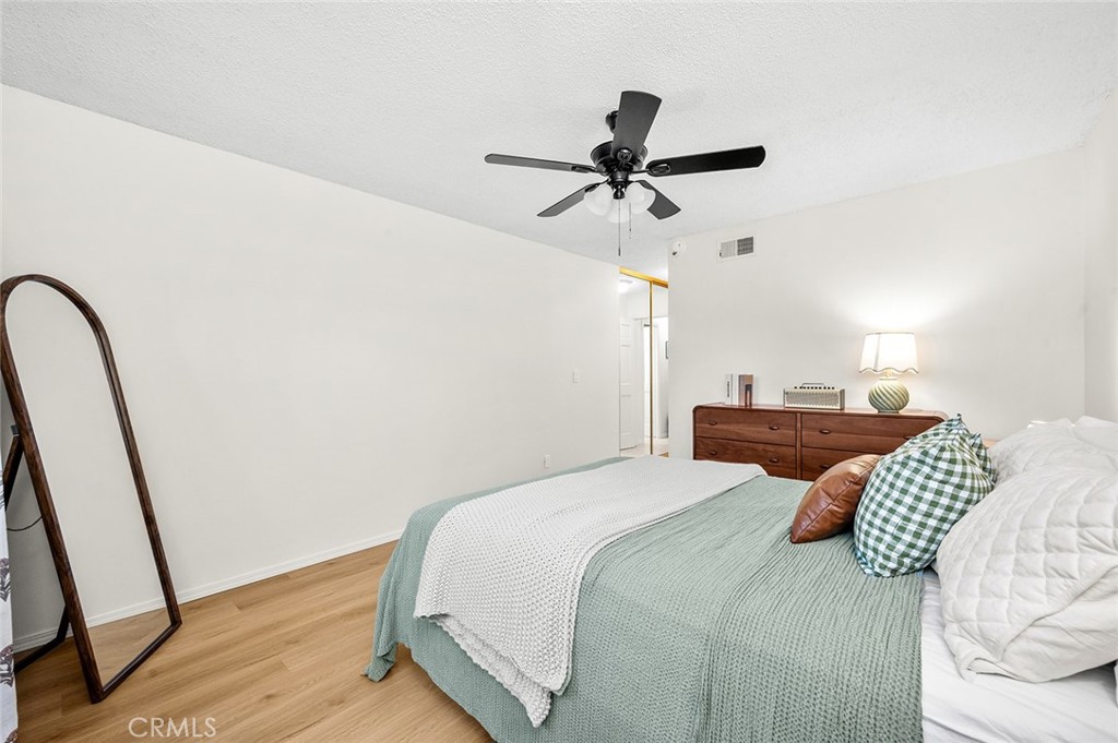 Spacious primary bedroom with new flooring and plenty of natural light - 1881 Mitchell Avenue 135, Tustin CA 92780 - photo 23