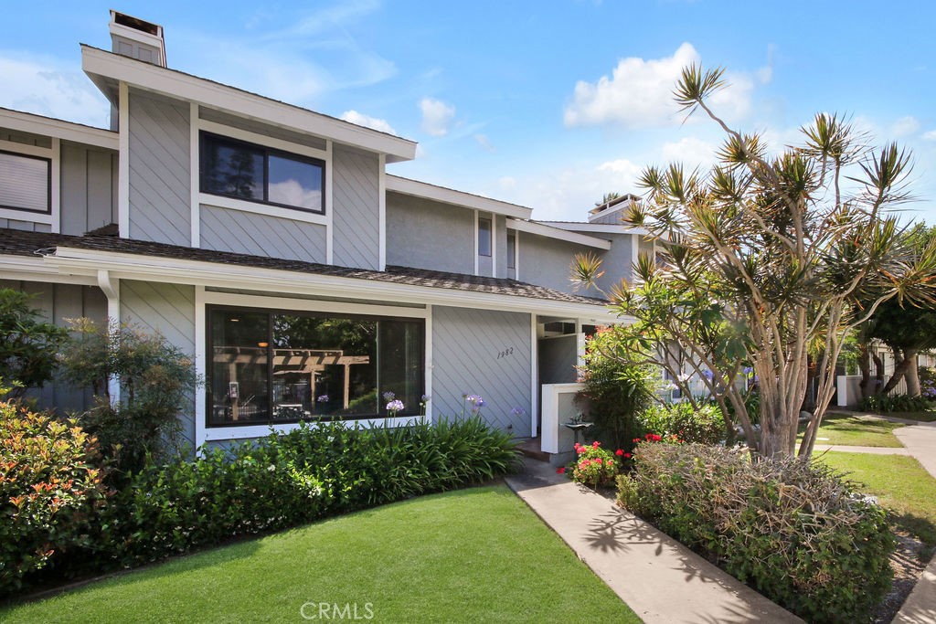 Attractive front exterior welcomes you with lush landscaping in a beautifully maintained community. - 1982 San Juan, Tustin CA 92780 - photo 1