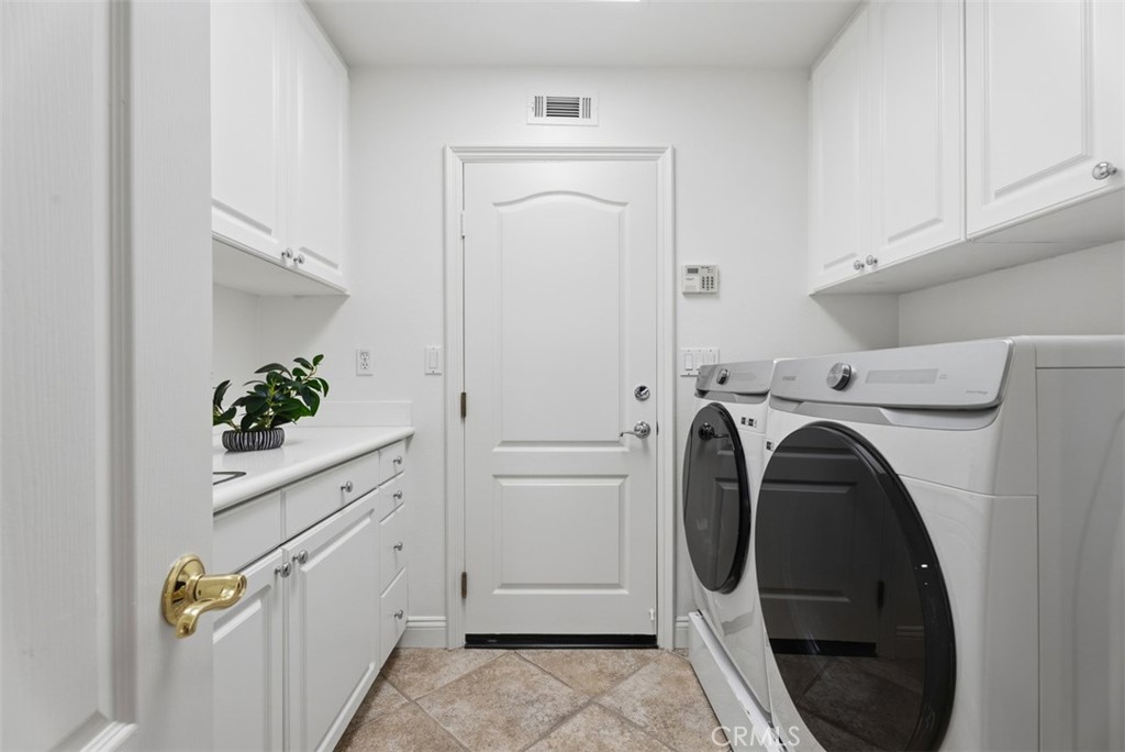 Laundry room with sink and cabinets - 2150 Chandler Drive, Tustin CA 92782 - photo 21