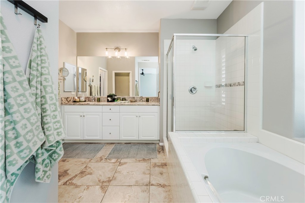 Primary bathroom with separate tub and shower. - 3216 Carrotwood, Tustin CA 92782 - photo 27