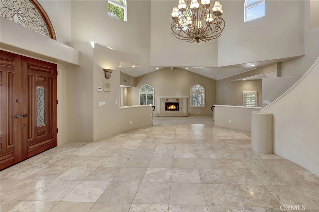 Grand entrance; Living Room (rear of photo) has AI-gen'd flames - 10762 Center Drive, Villa Park CA 92861 - photo 2