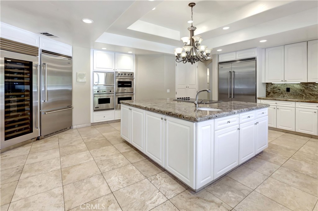 Kitchen: Sub-Zero wine cooler on the far left, 2 refrigerators, 3 ovens - 10762 Center Drive, Villa Park CA 92861 - photo 13