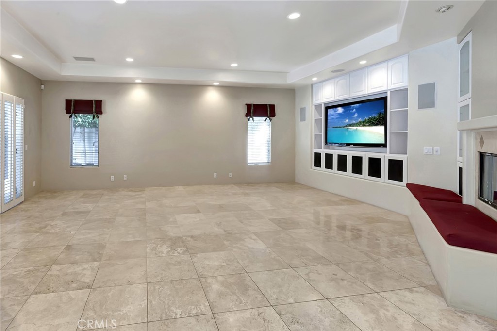 Family Room off the kitchen - with AI image on TV - 10762 Center Drive, Villa Park CA 92861 - photo 15