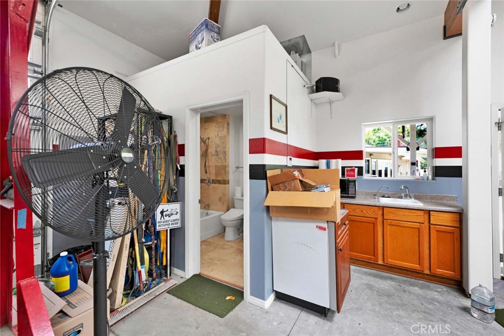 Inside of garage showing "wetbar" and bathroom entrance. - 18381 Serrano, Villa Park CA 92861 - photo 7