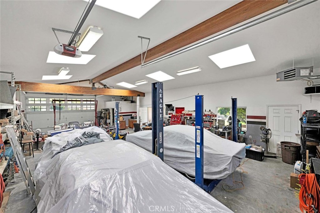 Interior of garage showing pedestrian door and door from driveway and gate. - 18381 Serrano, Villa Park CA 92861 - photo 11