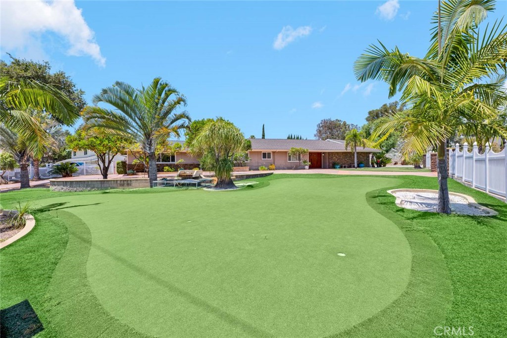 Beautiful and spacious front yard completely gated and fenced with wrought iron fencing, and artificial turf. - 18381 Serrano, Villa Park CA 92861 - photo 12