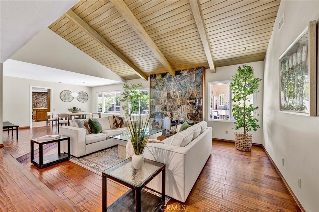 Living room with fireplace and hearth, vaulted ceiling. - 18381 Serrano, Villa Park CA 92861 - photo 14