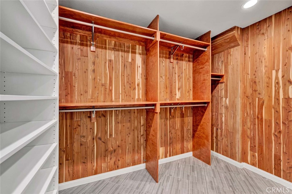 Primary walk in closet lined with cedar (to deter moths) and organizers. - 18381 Serrano, Villa Park CA 92861 - photo 21