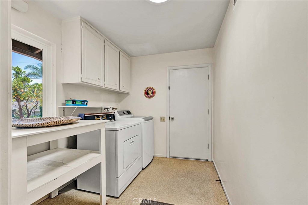 Laundry room with electrical and gas hook-ups. folding/storage table, upper cabinets and door leading to separate two-ca - 18381 Serrano, Villa Park CA 92861 - photo 35
