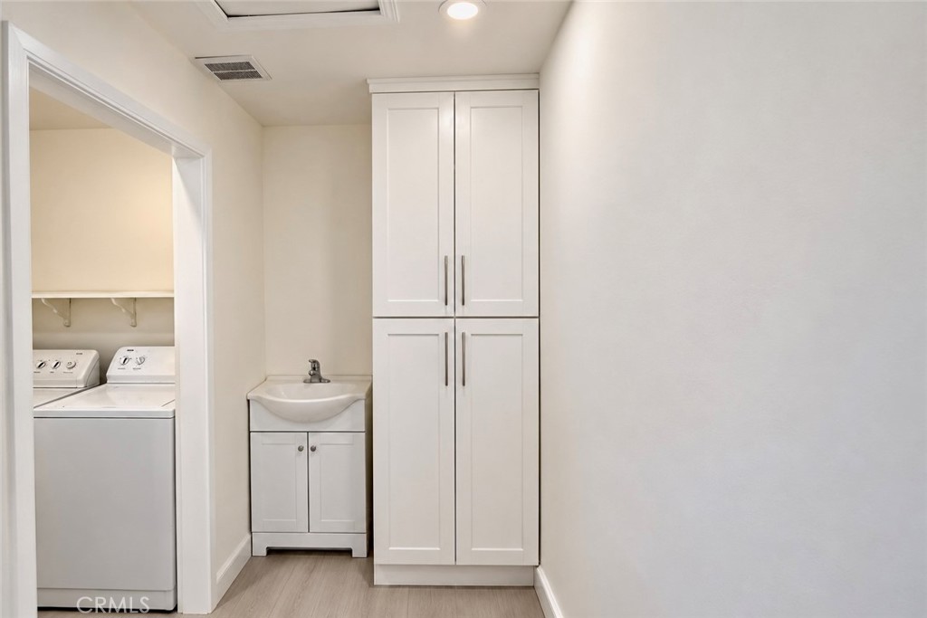 Laundry room with storage - 13281 Mono Place, Westminster CA 92683 - photo 39