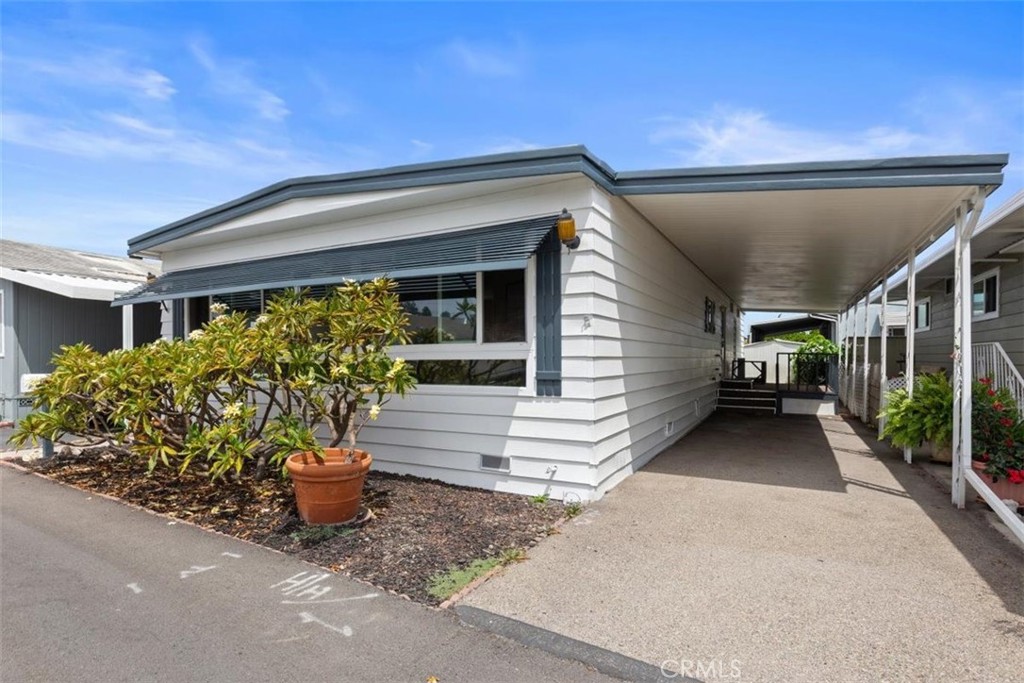 Front of the house with Carport space for up to two cars - 15621 Beach Blvd 103, Westminster CA 92683 - photo 2