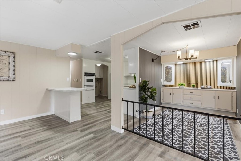 Open living area with kitchen and dining space. - 15621 Beach Blvd 103, Westminster CA 92683 - photo 6