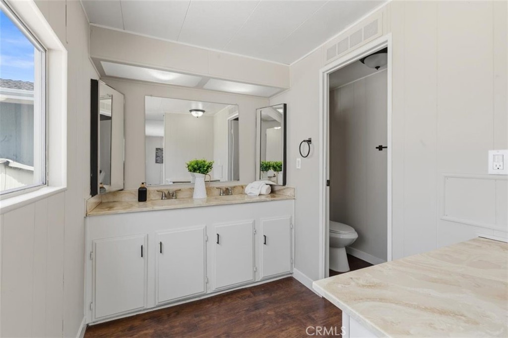 Bathroom with dual sinks and vanity. - 15621 Beach Blvd 103, Westminster CA 92683 - photo 14