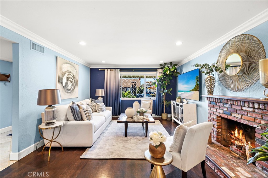 spacious living room features a brick fireplace - 16102 Nelson Street, Westminster CA 92683 - photo 5