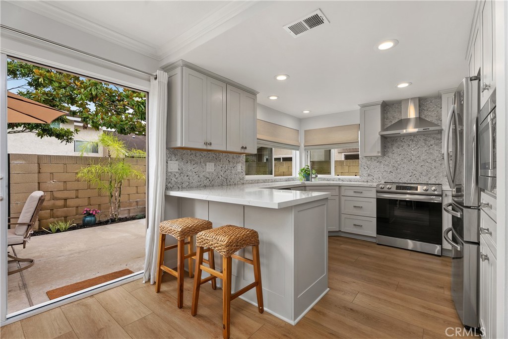 Sliding door to the back wrap around patio. - 5112 Kingscross, Westminster CA 92683 - photo 13