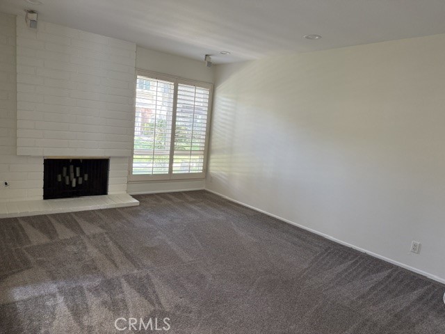 Living room with gas fireplace - 5281 Charing Cross Road, Westminster CA 92683 - photo 6