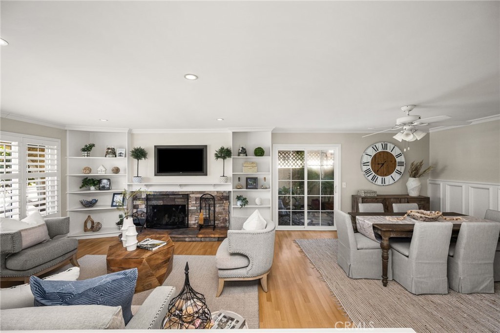 Living and dining areas with fireplace and built-in shelving. - 8981 Blackheath Circle, Westminster CA 92683 - photo 2