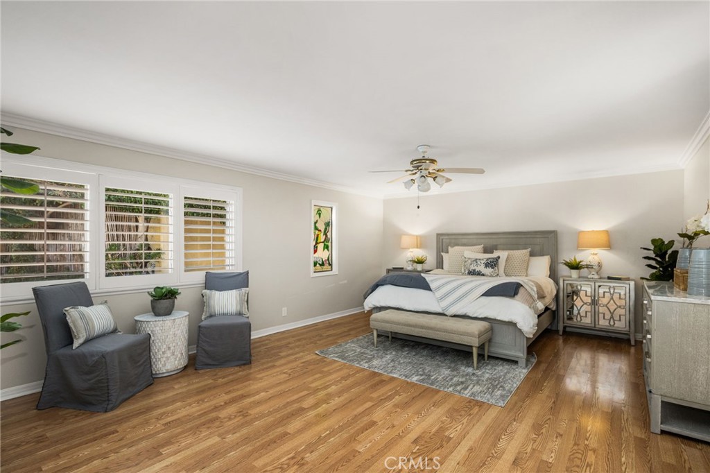 Spacious main-level primary bedroom with a sitting area. - 8981 Blackheath Circle, Westminster CA 92683 - photo 5