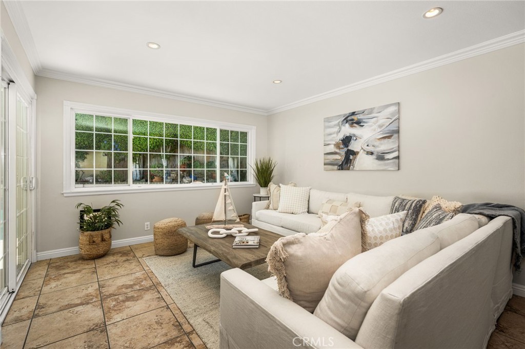 Family room with a large backyard-facing window. - 8981 Blackheath Circle, Westminster CA 92683 - photo 12