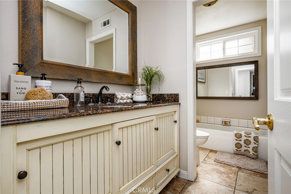 Main-level guest bathroom with a bathtub. - 8981 Blackheath Circle, Westminster CA 92683 - photo 16