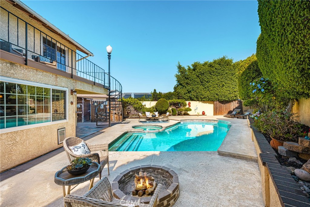 Poolside fire pit and outdoor seating. - 8981 Blackheath Circle, Westminster CA 92683 - photo 23