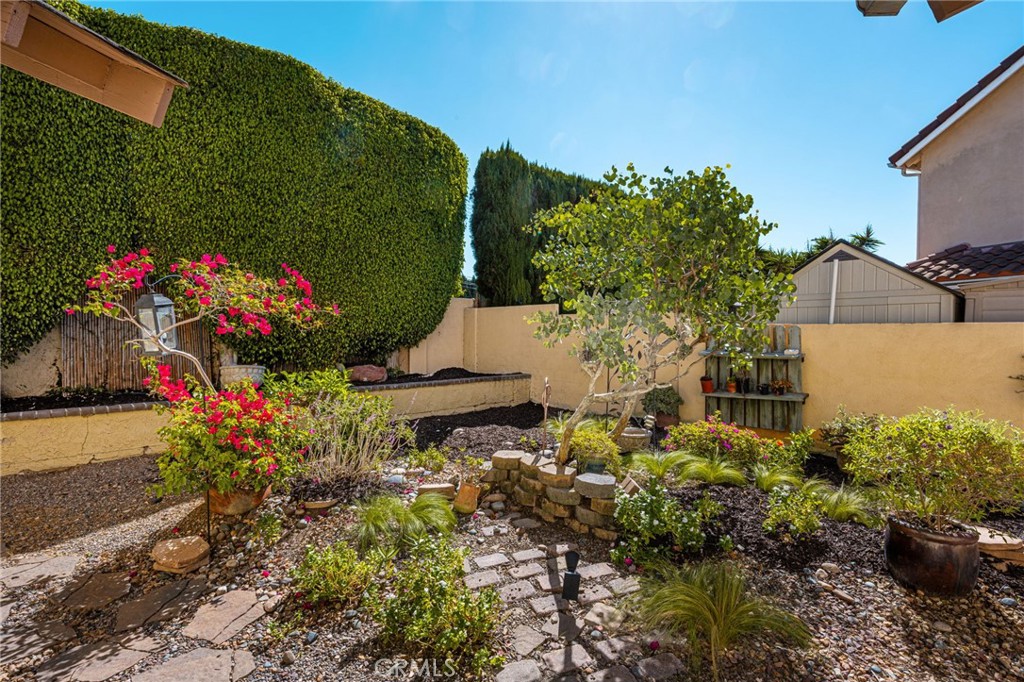 Garden area with landscaped beds and a stone path. - 8981 Blackheath Circle, Westminster CA 92683 - photo 24