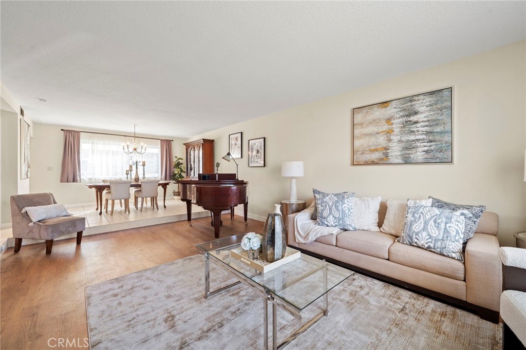 Double entry doors open to a formal foyer leading to an elegant step-down living room and a banquet-size formal dining r - 9552 Westwood Drive, Westminster CA 92683 - photo 5