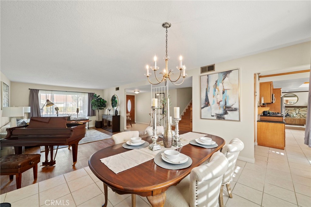 The home features dual-pane windows, smooth ceilings, crown molding, recessed lighting, a blend of tile and wood laminat - 9552 Westwood Drive, Westminster CA 92683 - photo 9