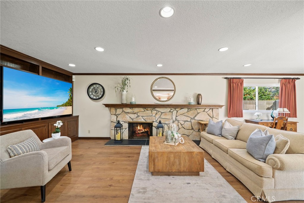 It is open to an extra large inviting family room with stone fireplace, wall-to-wall built in cabinetry and shelving, an - 9552 Westwood Drive, Westminster CA 92683 - photo 13