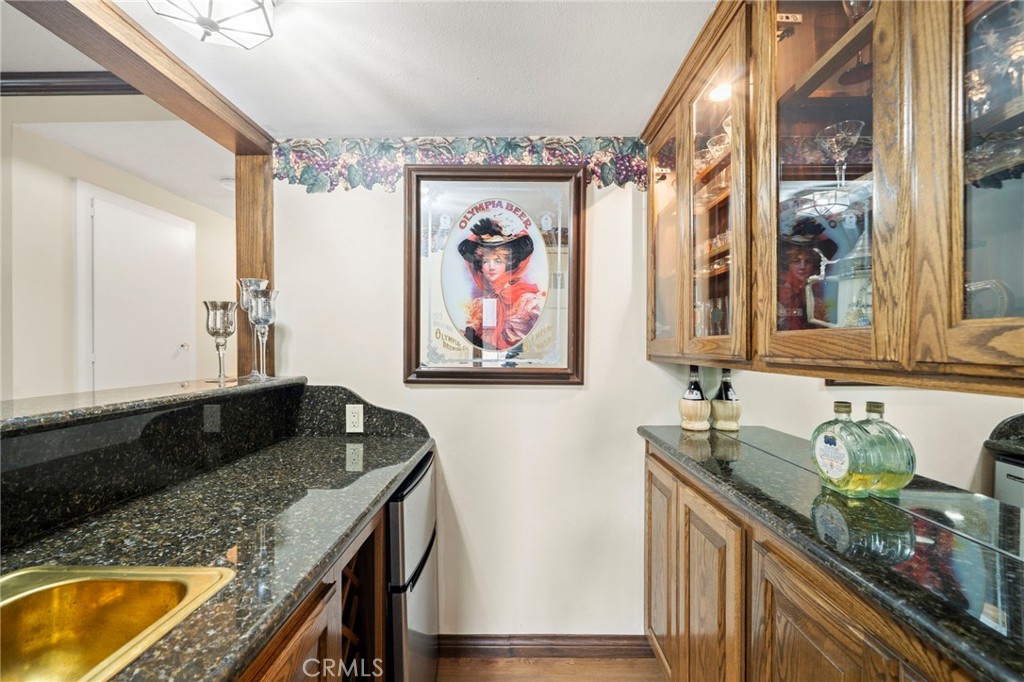 It is open to an extra large inviting family room with stone fireplace, wall-to-wall built in cabinetry and shelving, an - 9552 Westwood Drive, Westminster CA 92683 - photo 18