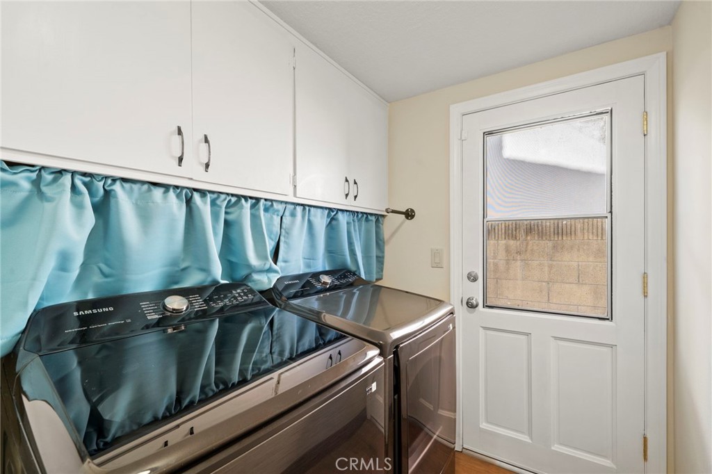 The main level also includes a tastefully appointed half bath, a convenient inside laundry room, and direct access to th - 9552 Westwood Drive, Westminster CA 92683 - photo 19
