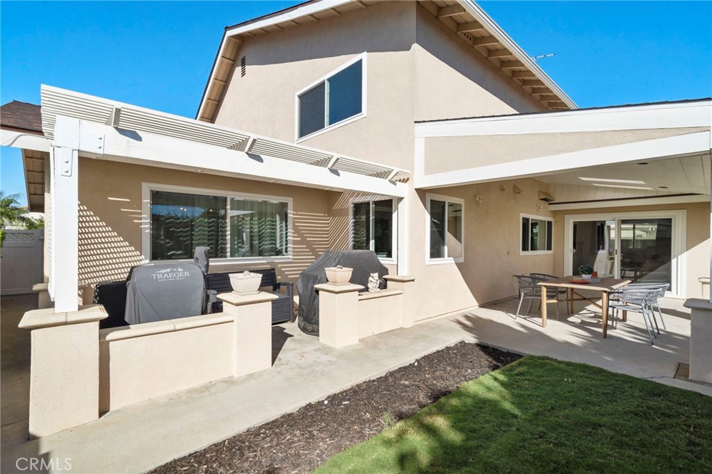 Sliding glass doors lead to the private backyard featuring a large patio with full covering of shiplap wood, recessed li - 9552 Westwood Drive, Westminster CA 92683 - photo 41