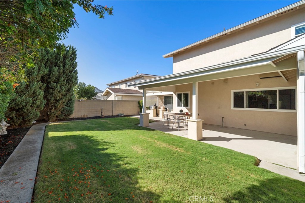 Sliding glass doors lead to the private backyard featuring a large patio with full covering of shiplap wood, recessed li - 9552 Westwood Drive, Westminster CA 92683 - photo 44