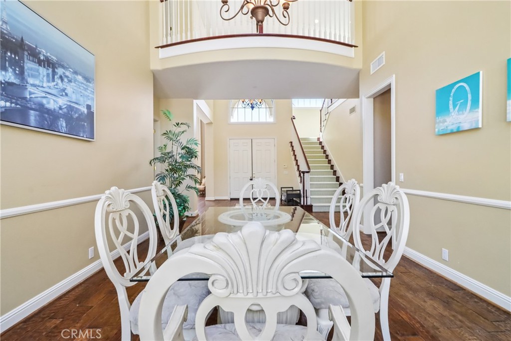 Dining area and view of front door, 2nd floor catwalk, stairs and bar entrance to right - 17218 Blue Spruce, Yorba Linda CA 92886 - photo 12