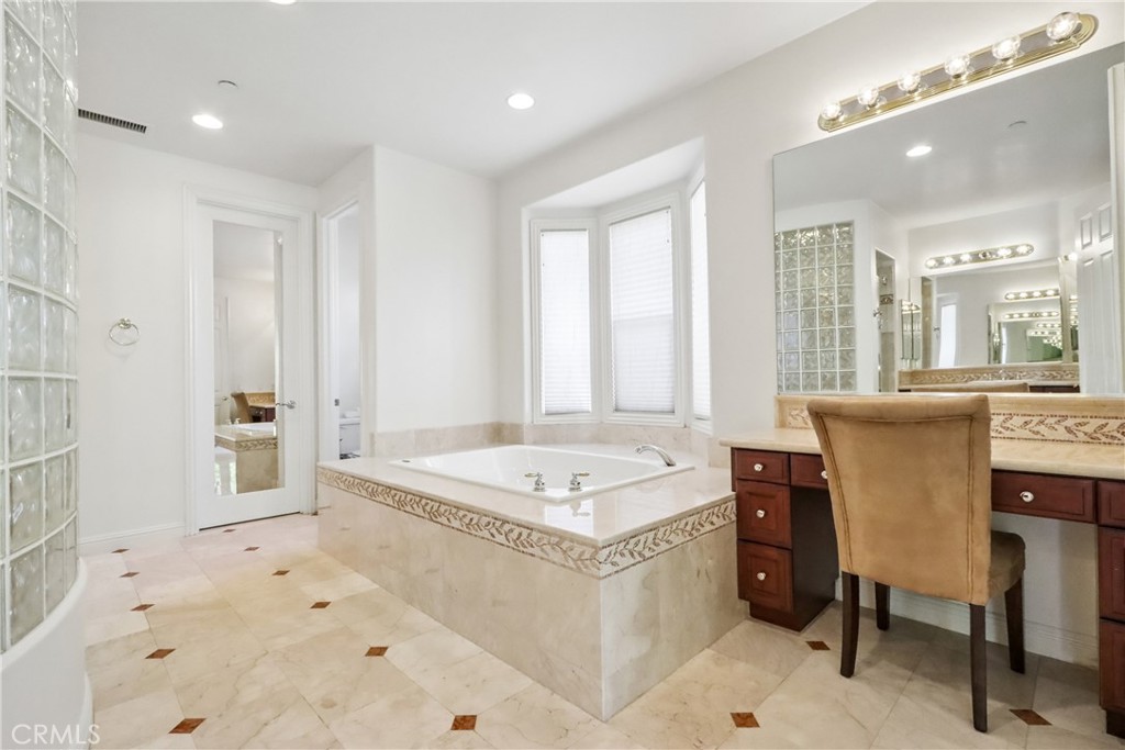 Primary room bathroom make up vanity, soaking bathtub and door to walk in closet #1 - 17218 Blue Spruce, Yorba Linda CA 92886 - photo 51