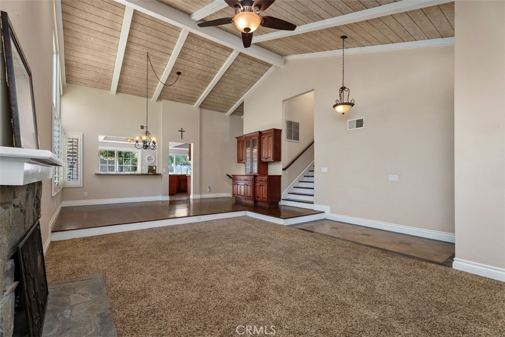 Another view of the living room, dining room as well as the opening to the kitchen and stairway to the upstairs bedrooms - 21674 Calle Alcazar, Yorba Linda CA 92887 - photo 6