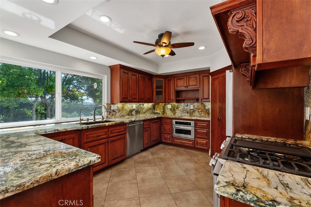 A great view to the green backyard through the window over the counter and sink. Note the recessed lighting and lighted - 21674 Calle Alcazar, Yorba Linda CA 92887 - photo 9