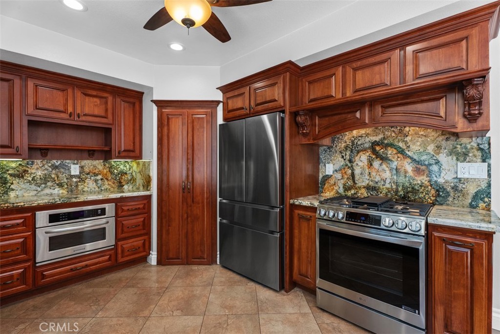Lots of cabinet and counter space along with a large pantry in this kitchen with easy care tile flooring. - 21674 Calle Alcazar, Yorba Linda CA 92887 - photo 10