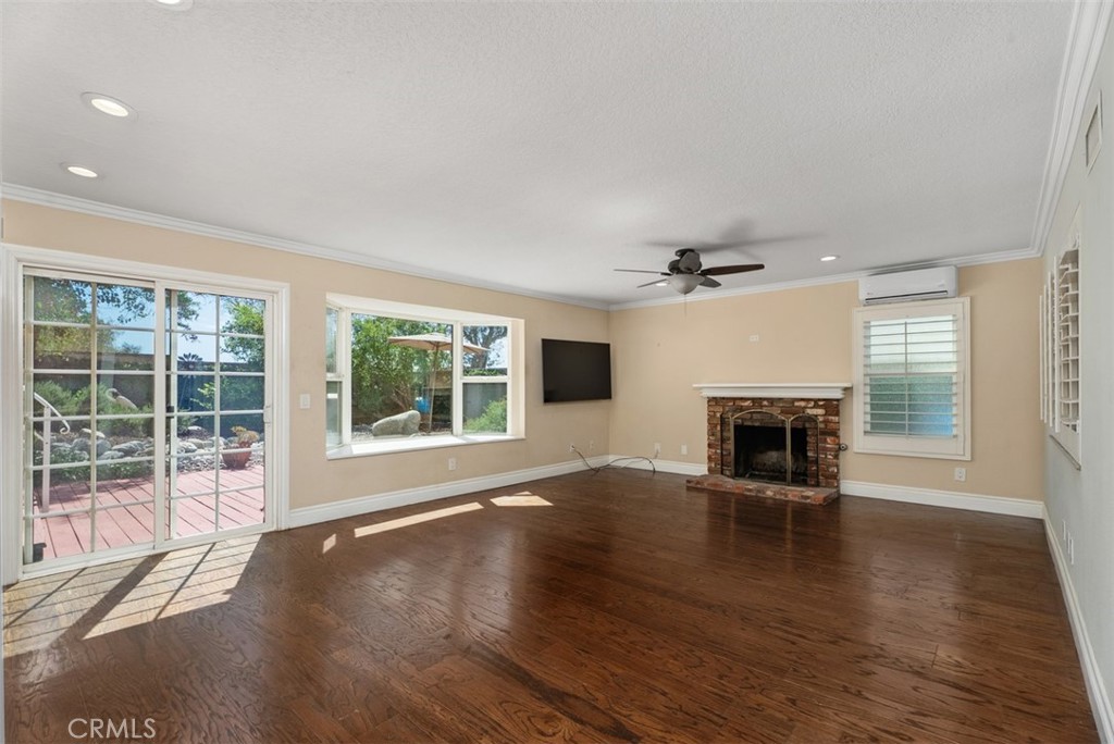 Spacious den with gas starter fireplace and slider to the backyard. - 21674 Calle Alcazar, Yorba Linda CA 92887 - photo 13