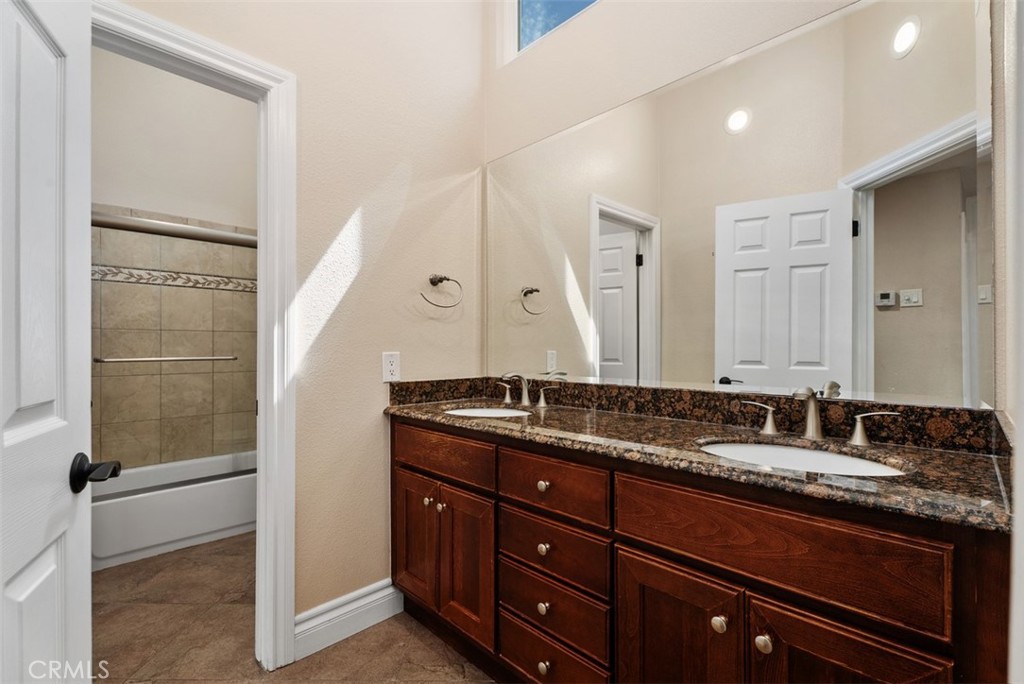 Upstairs full bath with dual sinks and private shower/toilet. - 21674 Calle Alcazar, Yorba Linda CA 92887 - photo 19