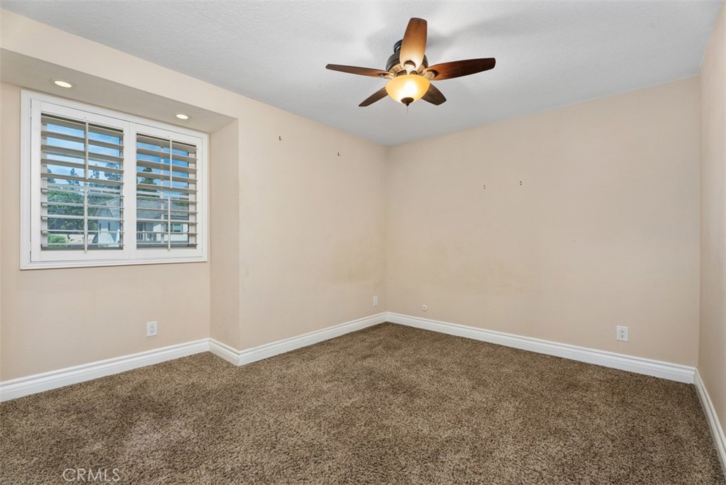 Bedroom #2 with lighted ceiling fan and carpeted flooring. - 21674 Calle Alcazar, Yorba Linda CA 92887 - photo 20