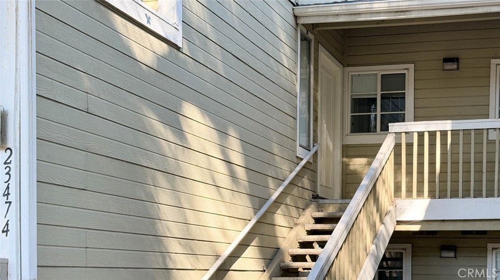 The staircase leads to the property on the 2nd floor. - 23472 Cambridge Road 297, Yorba Linda CA 92887 - photo 2