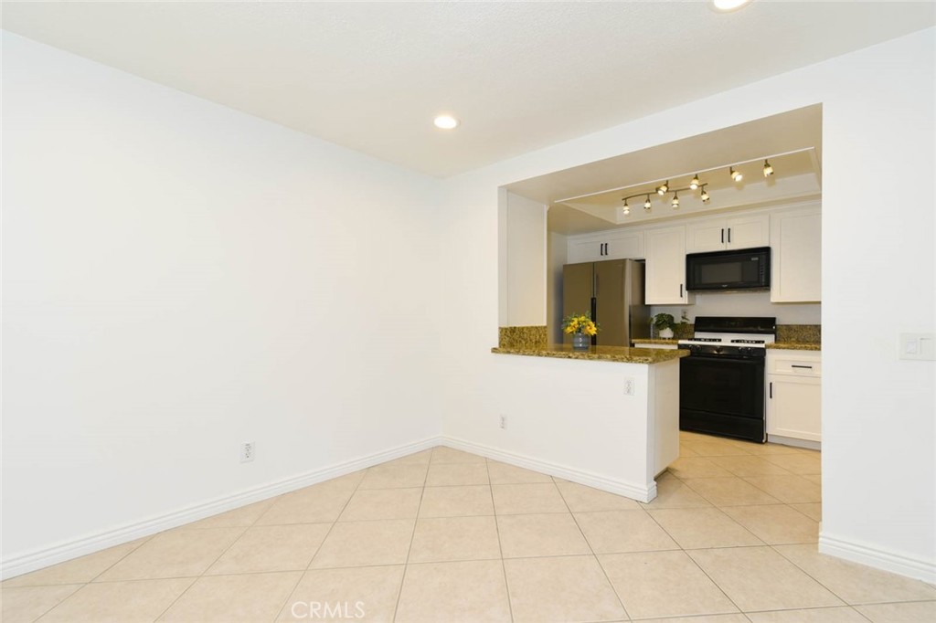 The remodeled kitchen is adjacent to the dining room. - 23472 Cambridge Road 297, Yorba Linda CA 92887 - photo 10