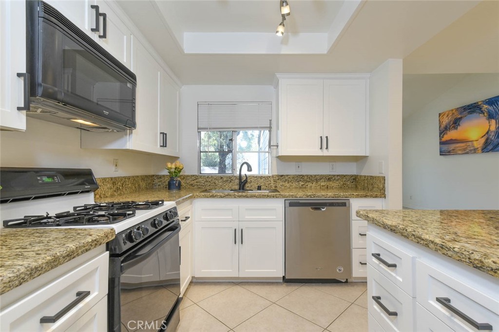 The window above the double sink bring the light into the kitchen. - 23472 Cambridge Road 297, Yorba Linda CA 92887 - photo 12